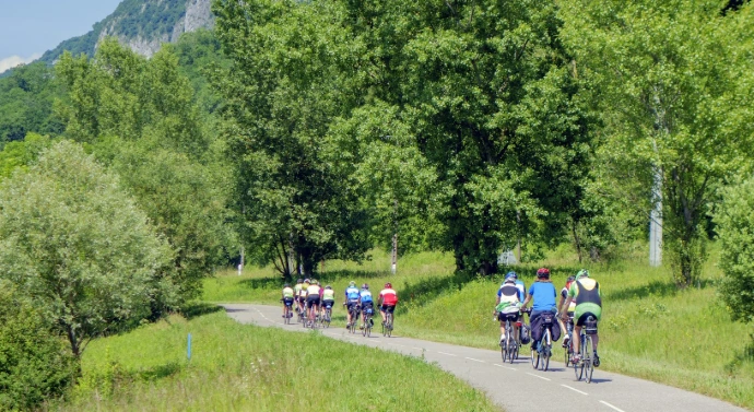 a group of people riding bikes down a road